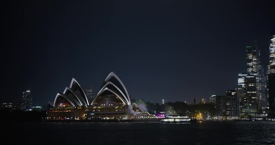 View of the sydney opera house at night by the waterfront