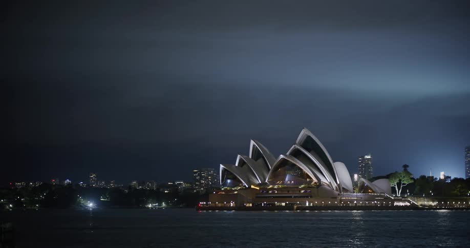View of the sydney opera house by the waterfront at night