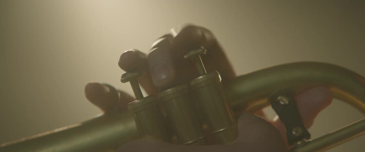 A person plays an instrument in a smoky room