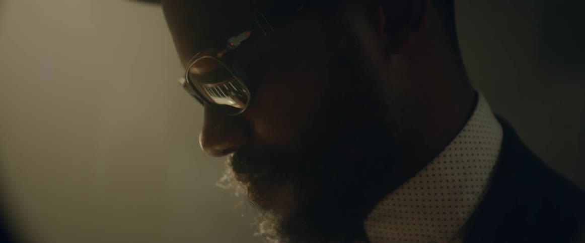 A pianist wearing glasses plays while nodding his head