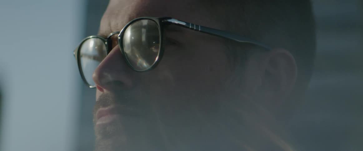 Close up of a man wearing glasses outside