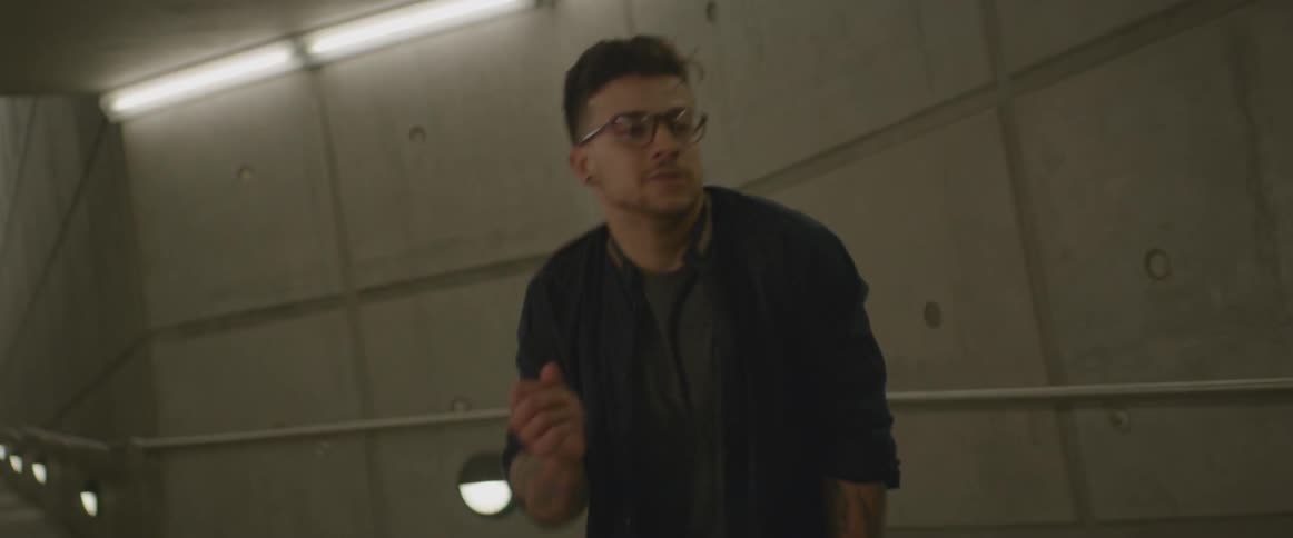 A man is dancing in a tunnel