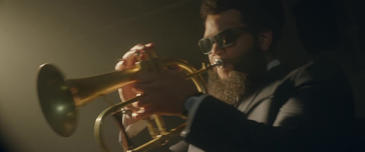 A musician starts to play his horn