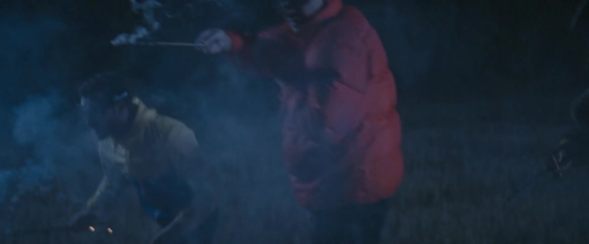 Group of people shooting fireworks at a target at night