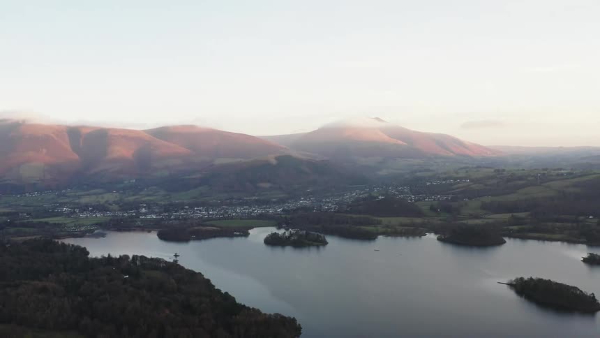 Skyline of a lake surrounded by forest in a rural town