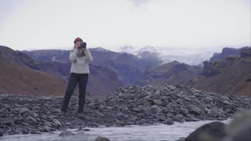 Photographer takes pictures of the wilderness next to the mountains