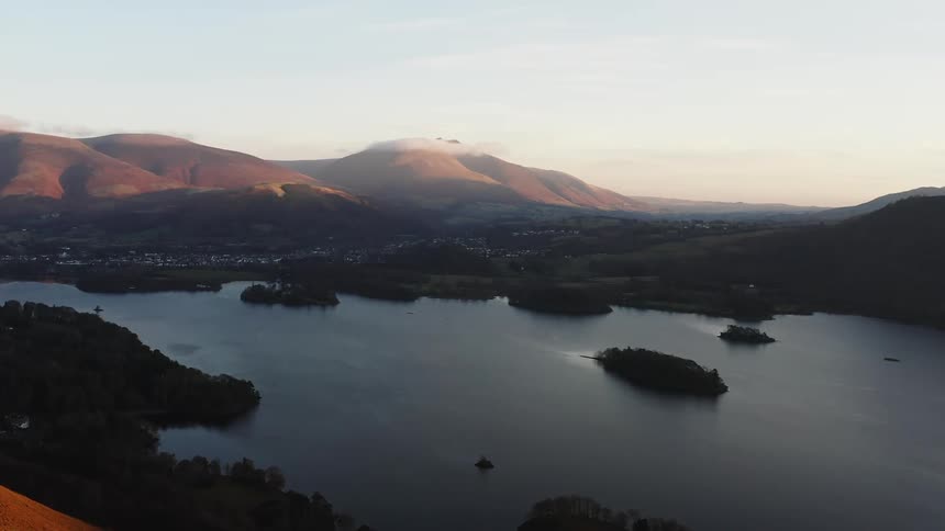 A calm lake is in the middle of the mountains