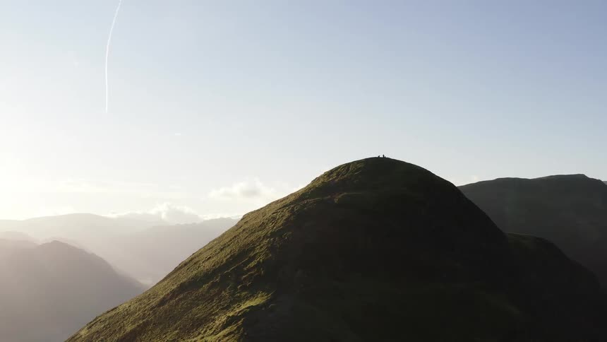 Aerial panorama of people on the peaks of a mountain in the morning