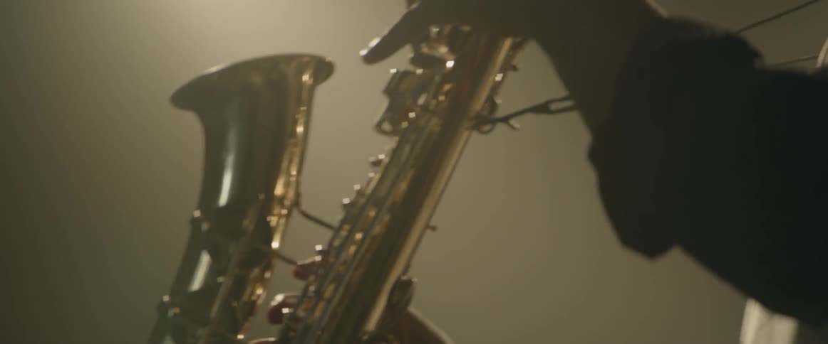 Man on stage playing saxophone