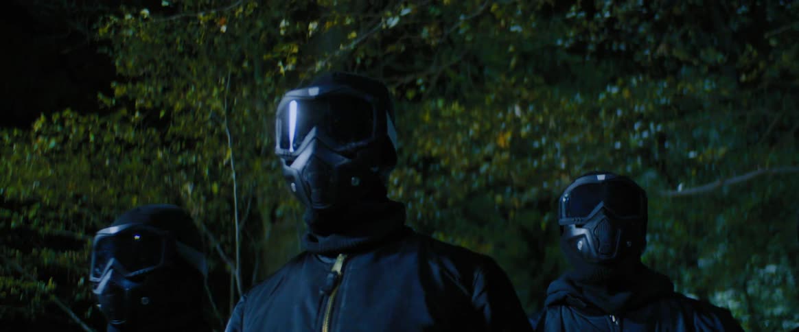 Three people putting on mask walking slowly in the woods