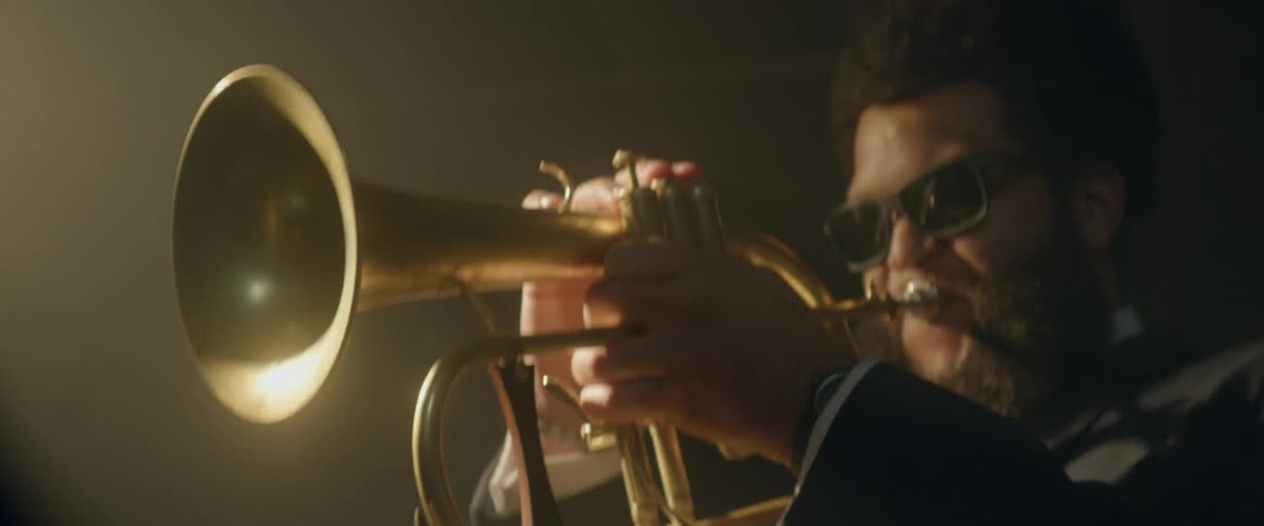 A man is playing the tuba