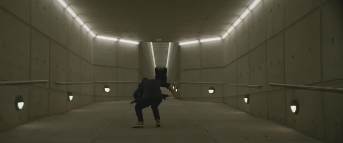 A man is break dancing in a room near a hall