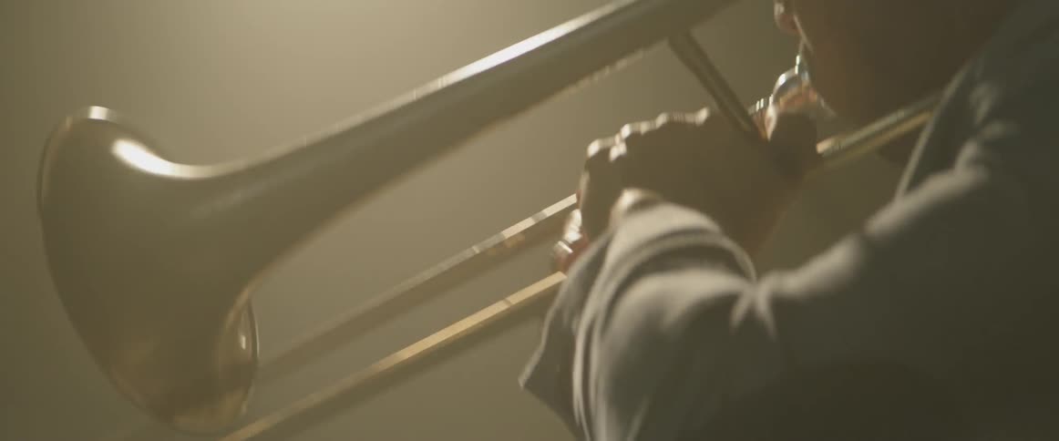 A man is playing a trombone