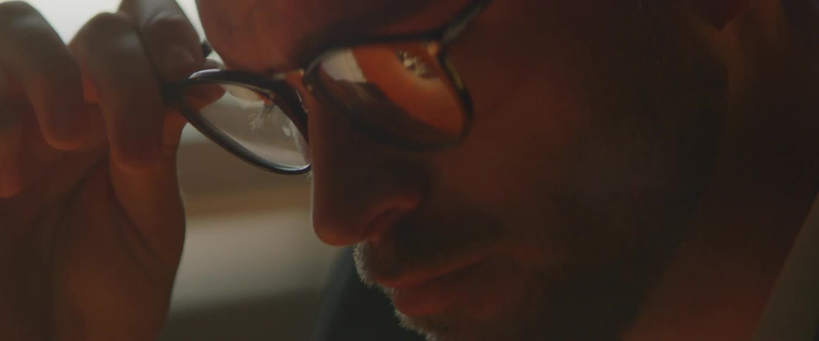 A man puts on a pair of glasses