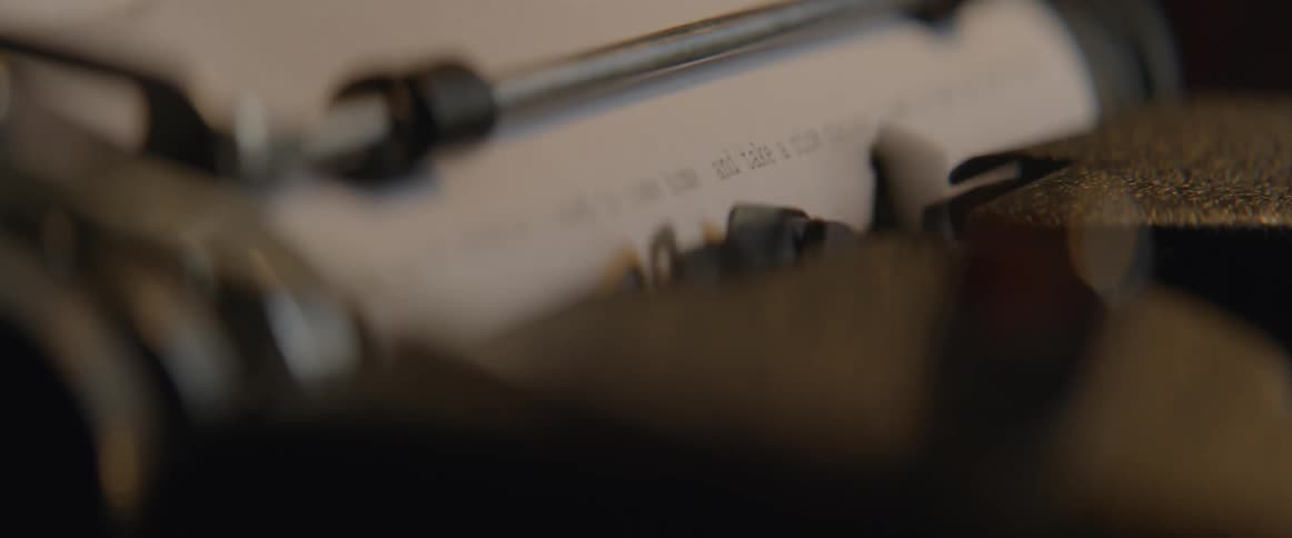 A typewriter is putting out words on a paper