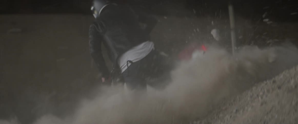 A man is making a sharp turn on a motorcycle