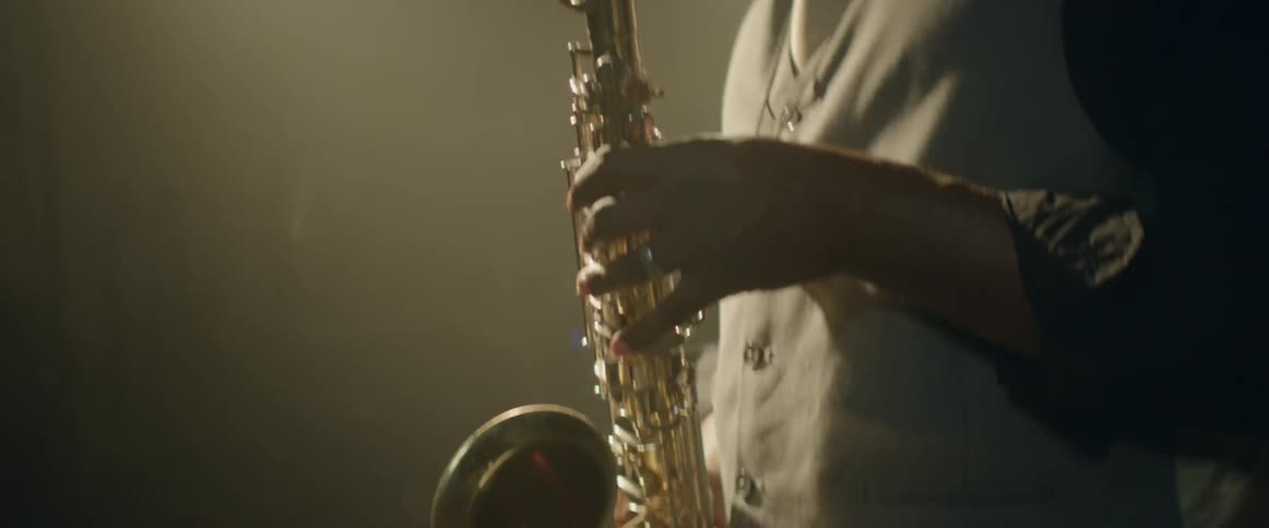 A man is playing the saxophone