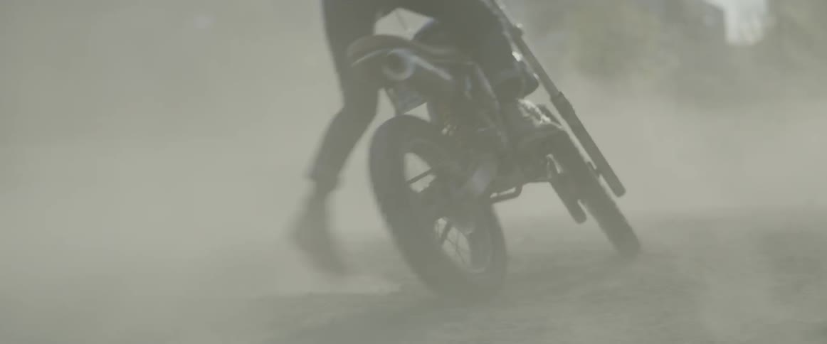 Men on motorcycles are spinning in circles kicking up dust