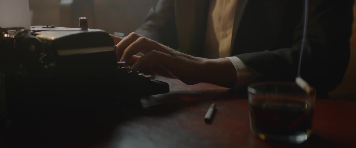 A man is typing on a typewriter in an office