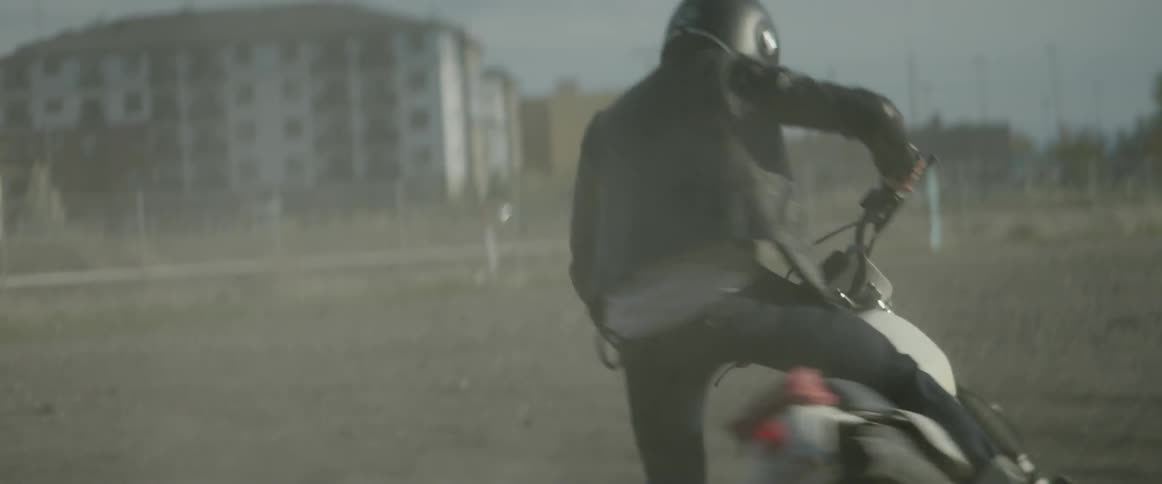 A man on a motorcycle is spinning in circles