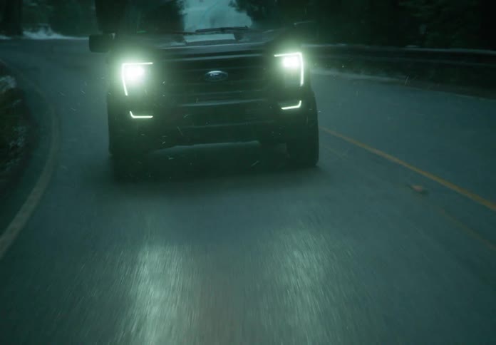 Pickup truck driving on a road at evening