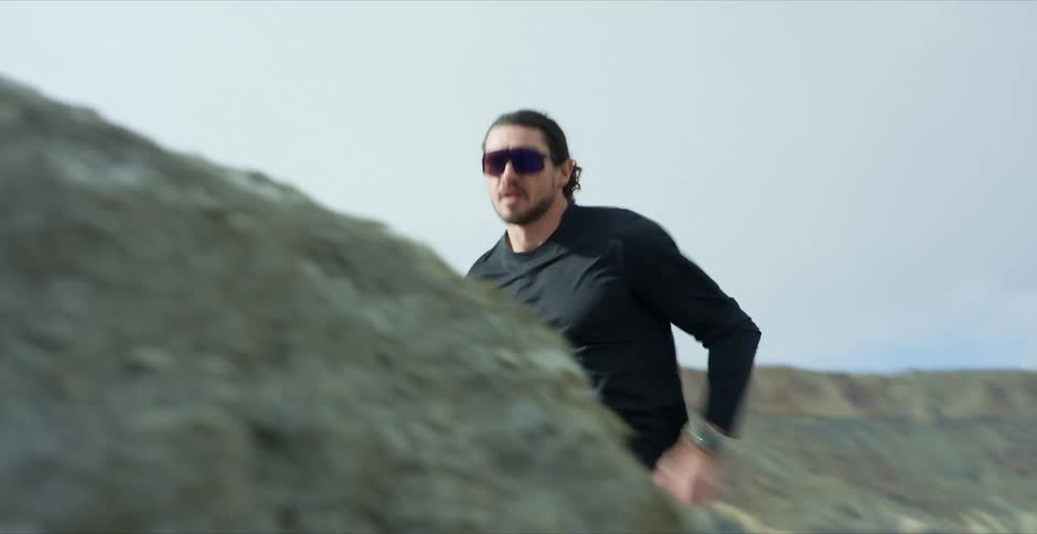 A man is running on the hills in the canyon