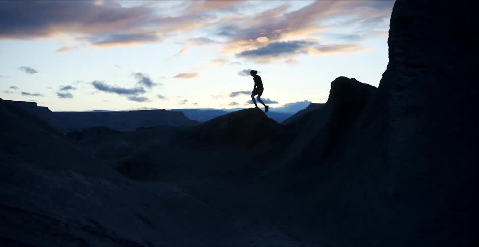 A person rock climbing at sunrise