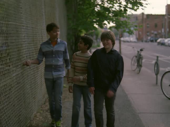 A clip of young boys playing on the road