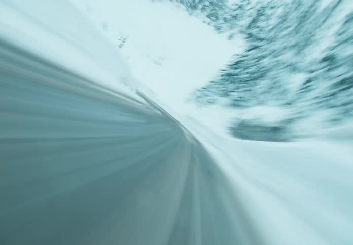 A truck is passed by on a ice filled road