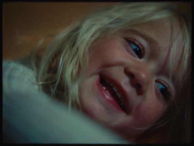A face of a happy blonde little girl