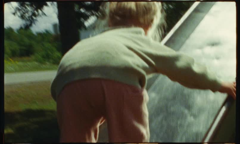 A child is climbing up the slide