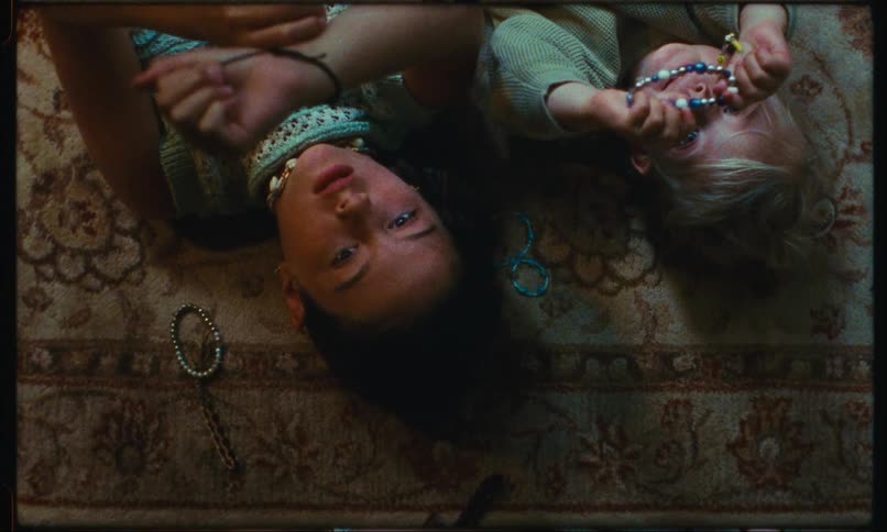 Brothers lying on the carpet with bracelets on their wrists