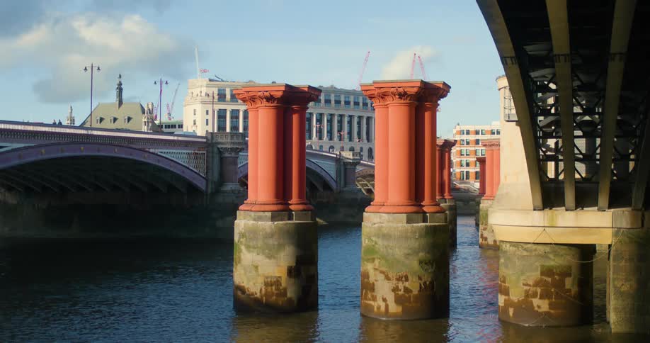 People walk over the stone bridge