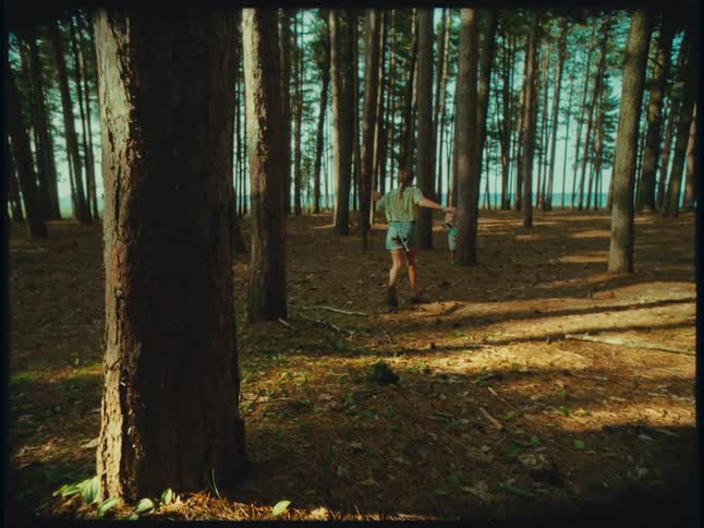 A young girl running through the forest