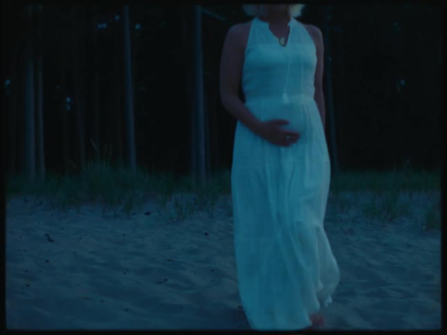 A woman walks onto the beach