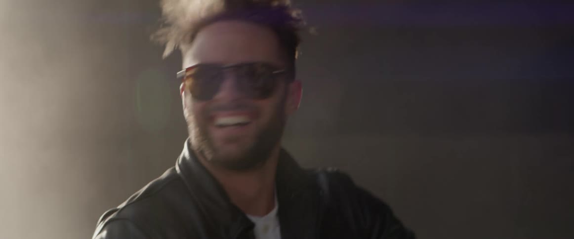 Man wearing sunglasses looking around laughing wildly