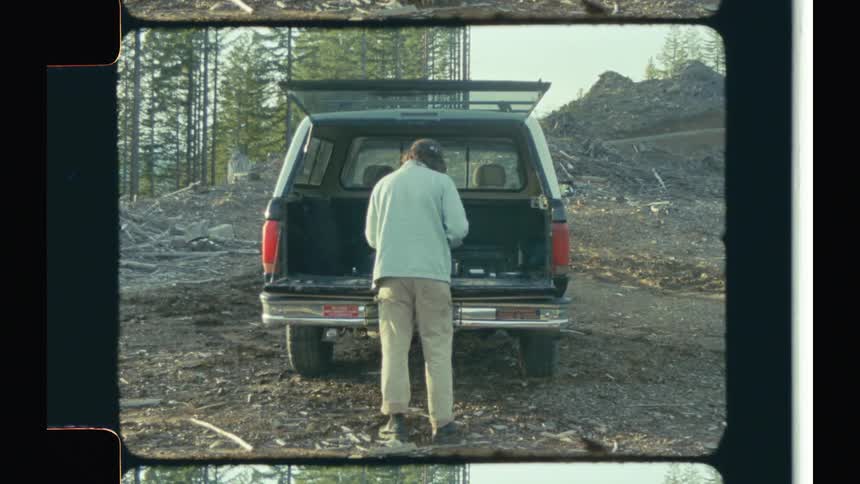 Man camping in the mountains caught on vintage film