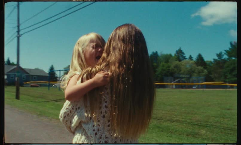 Girl carrying her crying sister on her arms