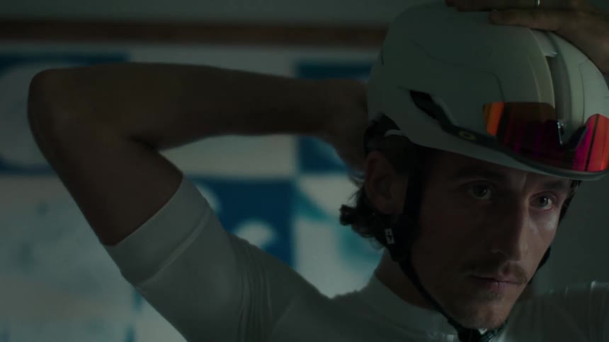 Man puts on a white cyclist helmet