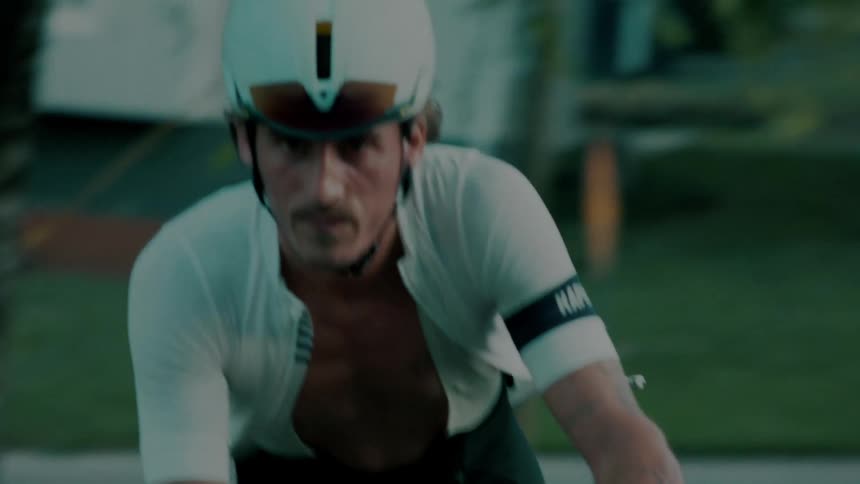 Cyclist with open shirt pedaling around the neighborhood
