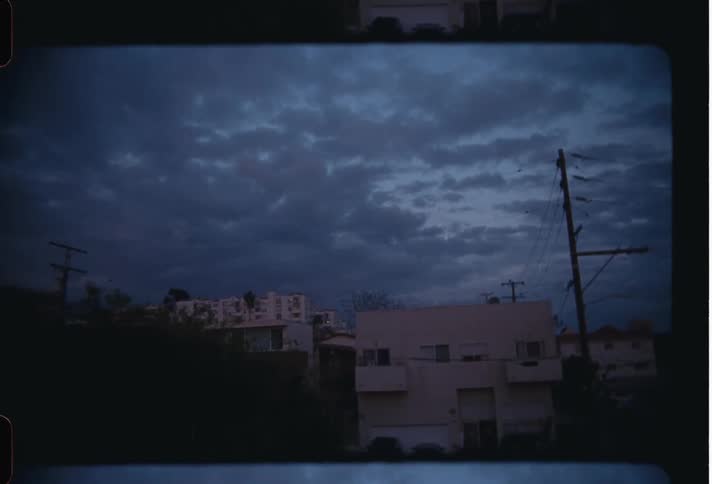 View of residential buildings in the midst of an urban neighborhood with a cloudy sky in the morning