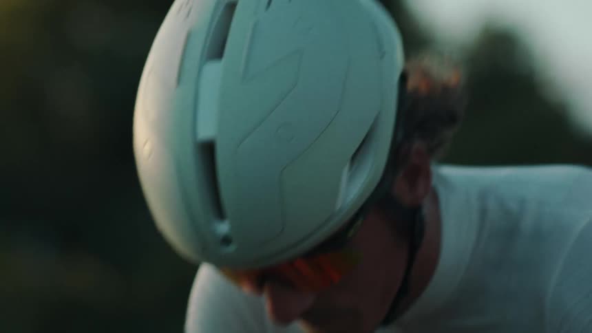 Closeup of a cyclists face in motion with a determined expression
