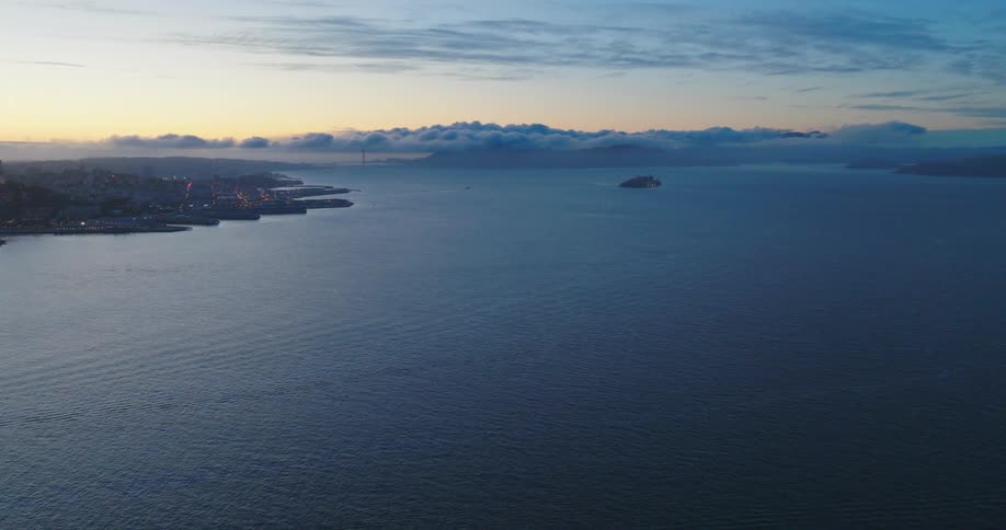 An aerial view of the sea and a land to the left