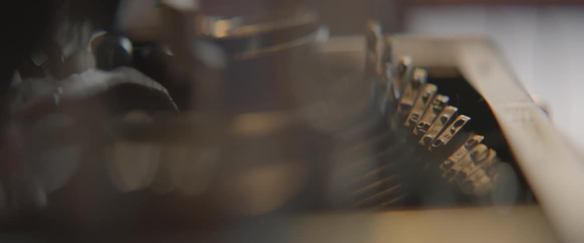 A typewriter is working with the keys moving