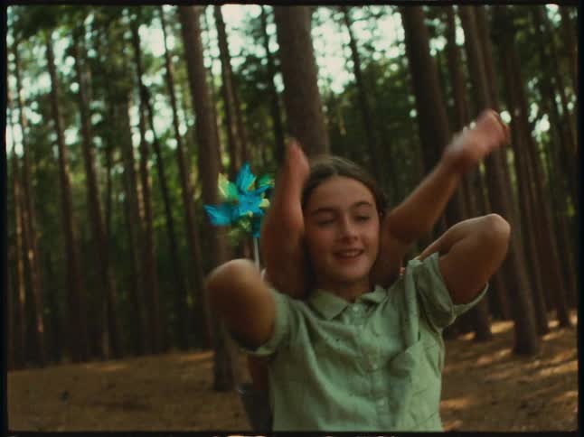 Girl is carrying her little sister on their back in a forest