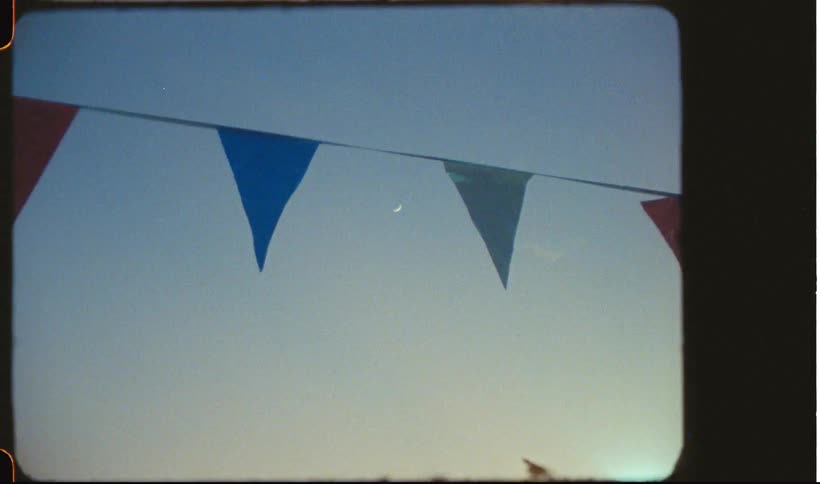 Some colorful flags hanging from a black thread