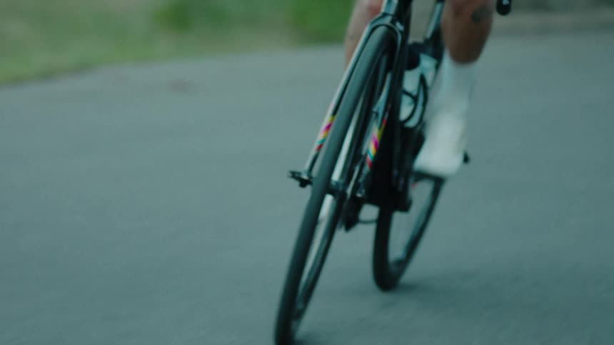 Cyclist pedaling on her bicycle on an uphill road