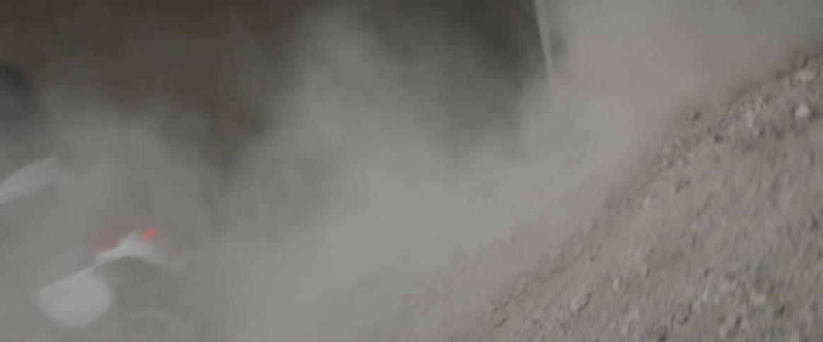 A motorcycle turns quickly in the rocks