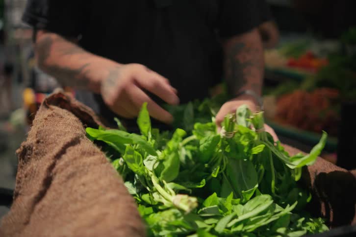 A person wrapping and unwrapping some food