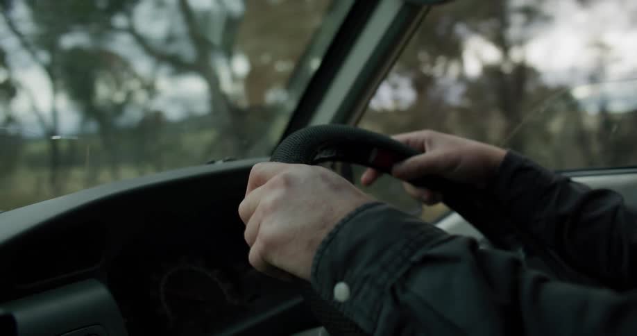 A man is driving a car